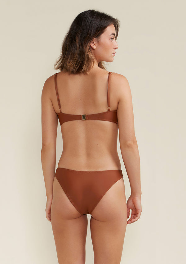 Model wearing blake scoop bikini top colour earth brown back view
