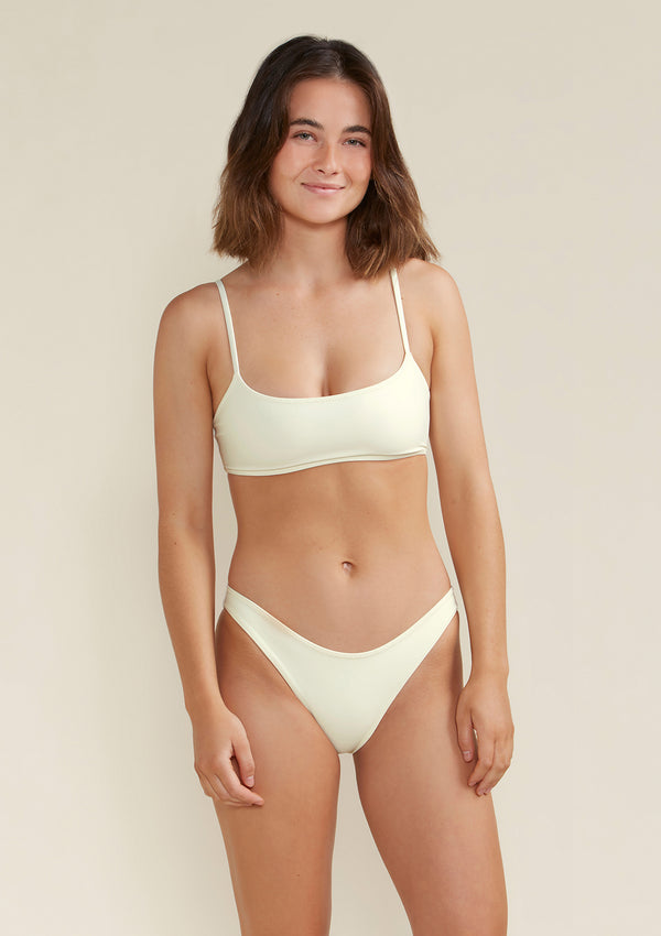 Model wears Alex scoop bikini tom and bottom in white dusk colour