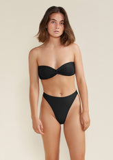 Model wearing frankie bandeau bikini top black