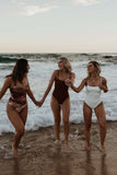 Three models are wearing Tama Swim harlow One Piece at the beach