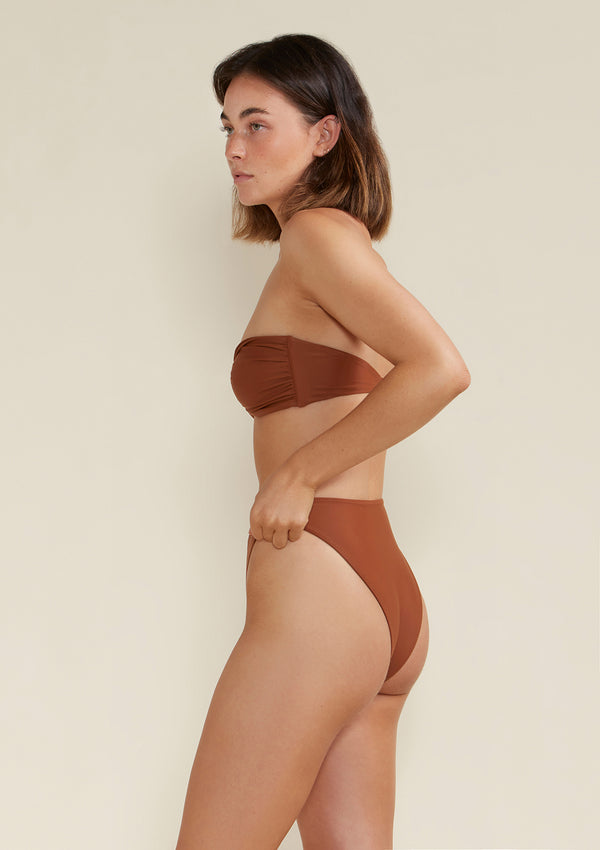 Model is wearing the frankie bandeau top in earth brown colour