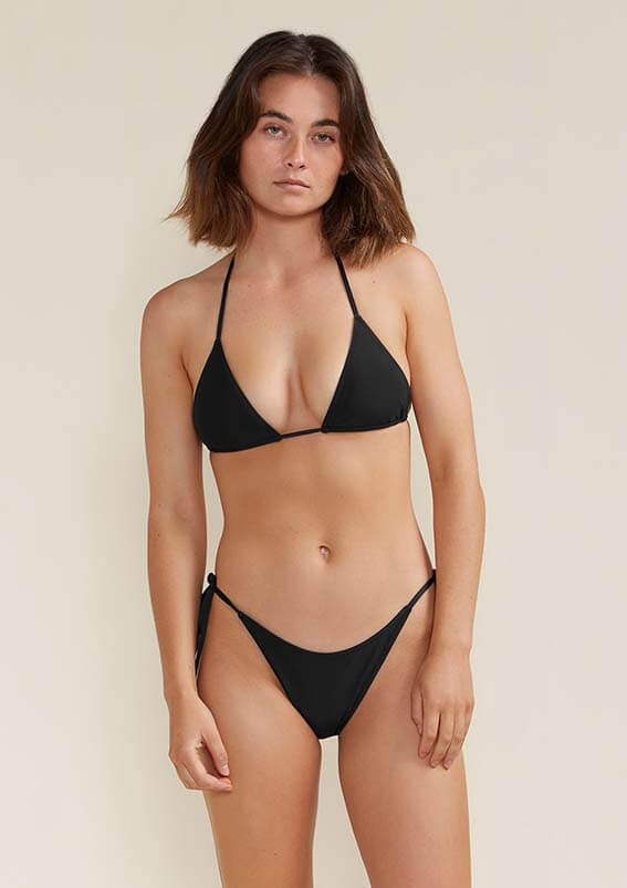 Model wears black string Tama bikini bottom 