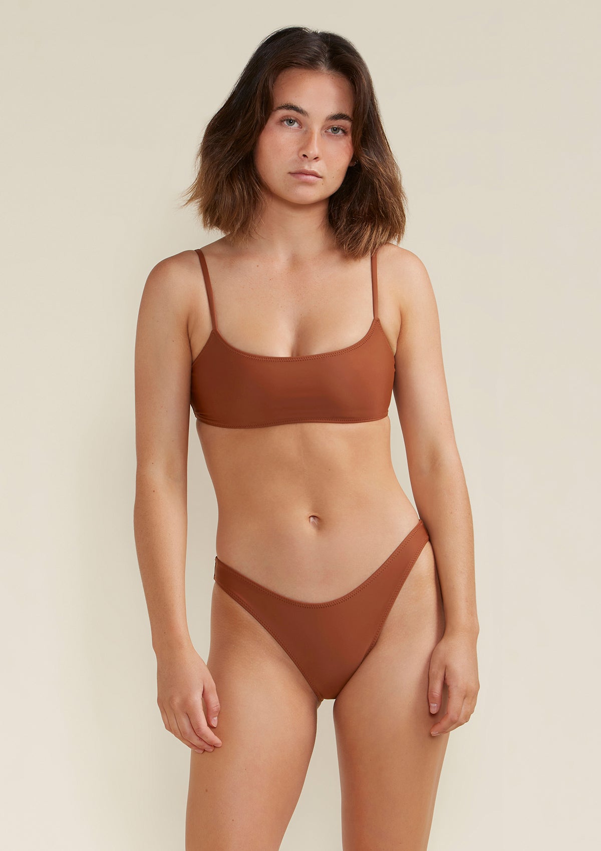 Model wears blake scoop bikini top earth brown colour