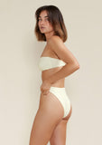 Model wears tama swim frankie bandeau bikini top in white dusk colour